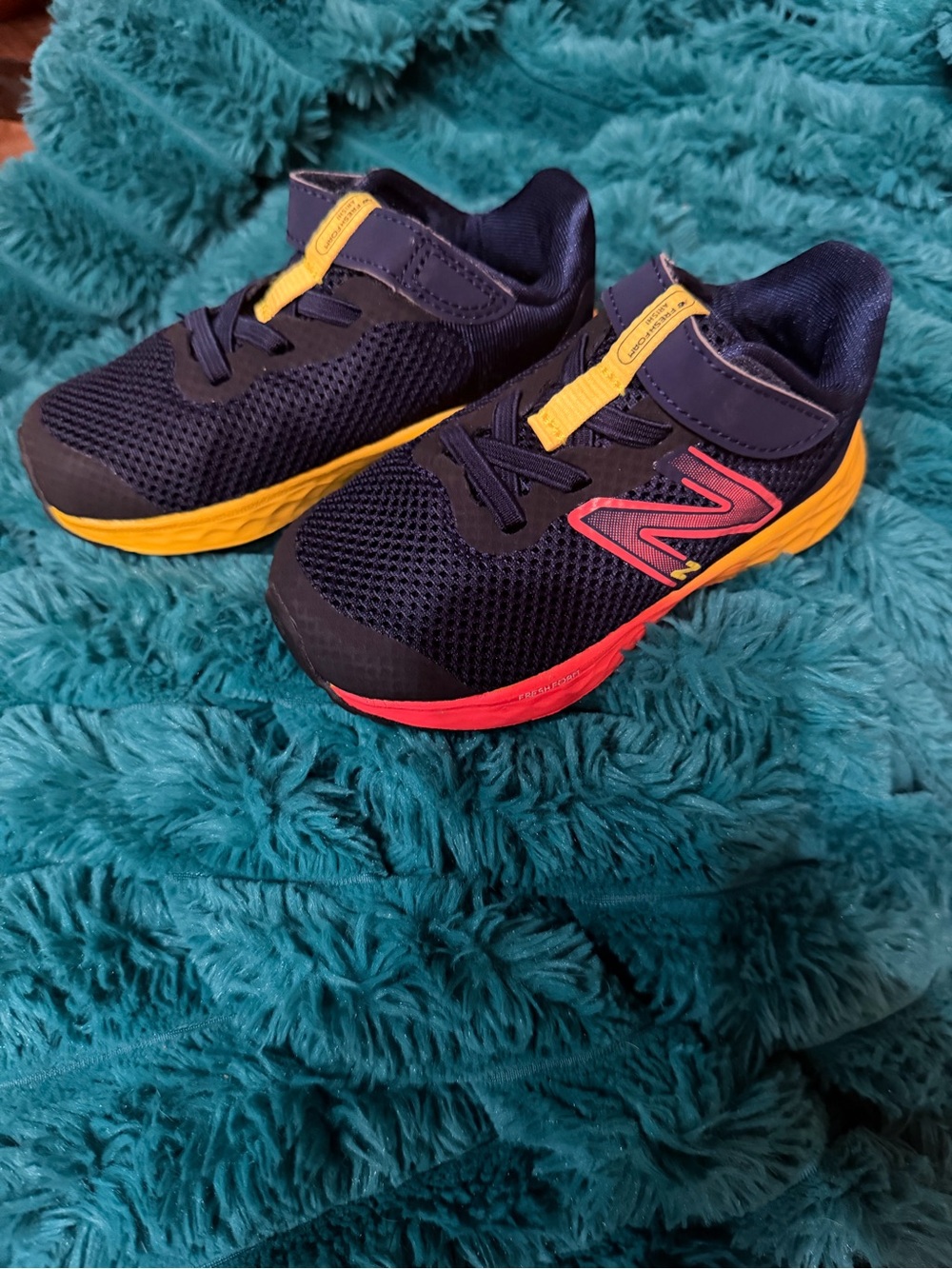New Balance Kids Navy with Yellow and Red Accent Sneakers